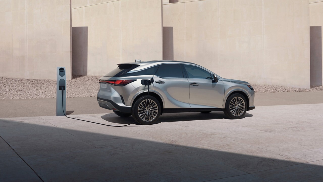 Lexus RX 450h+ plugged into a charging tower